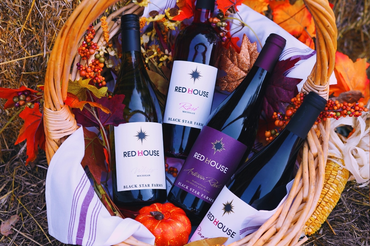 Untitled design - 2024-10-07T161555.235 Red House Wine collection in a basket with fall decorations.