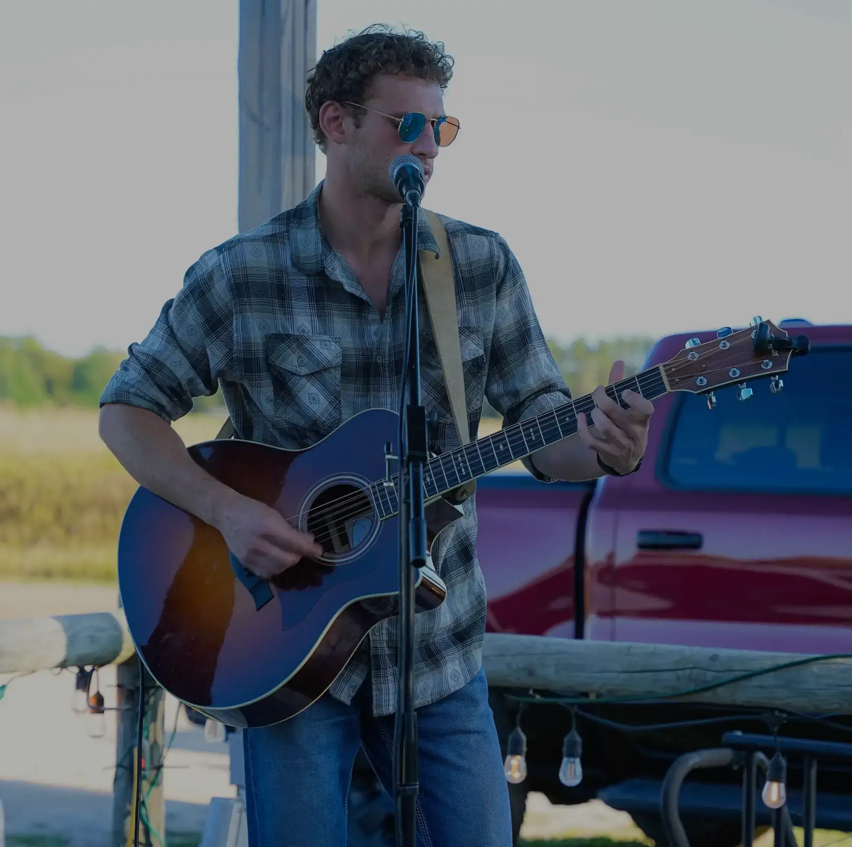 Live Music 3 Jakob Abraham playing guitar and singing.